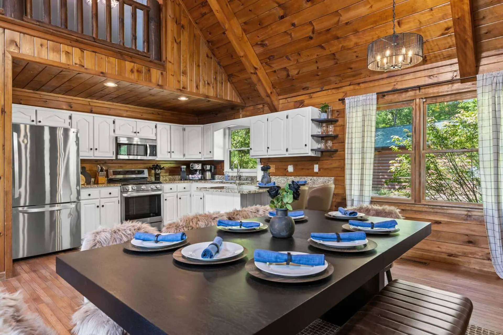 Gather around the spacious dining table in this warm, wood-lined cabin with soaring ceilings and a loft above.