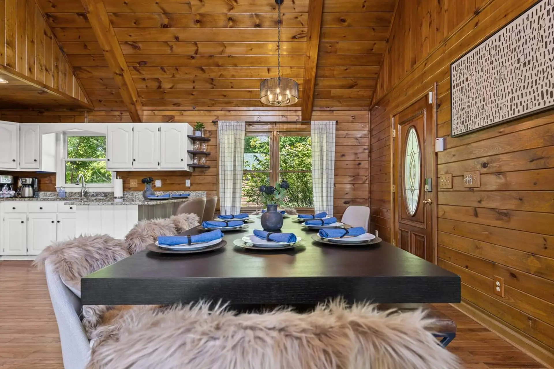 Natural light pours in from large windows, creating the perfect gathering space just steps from the open kitchen