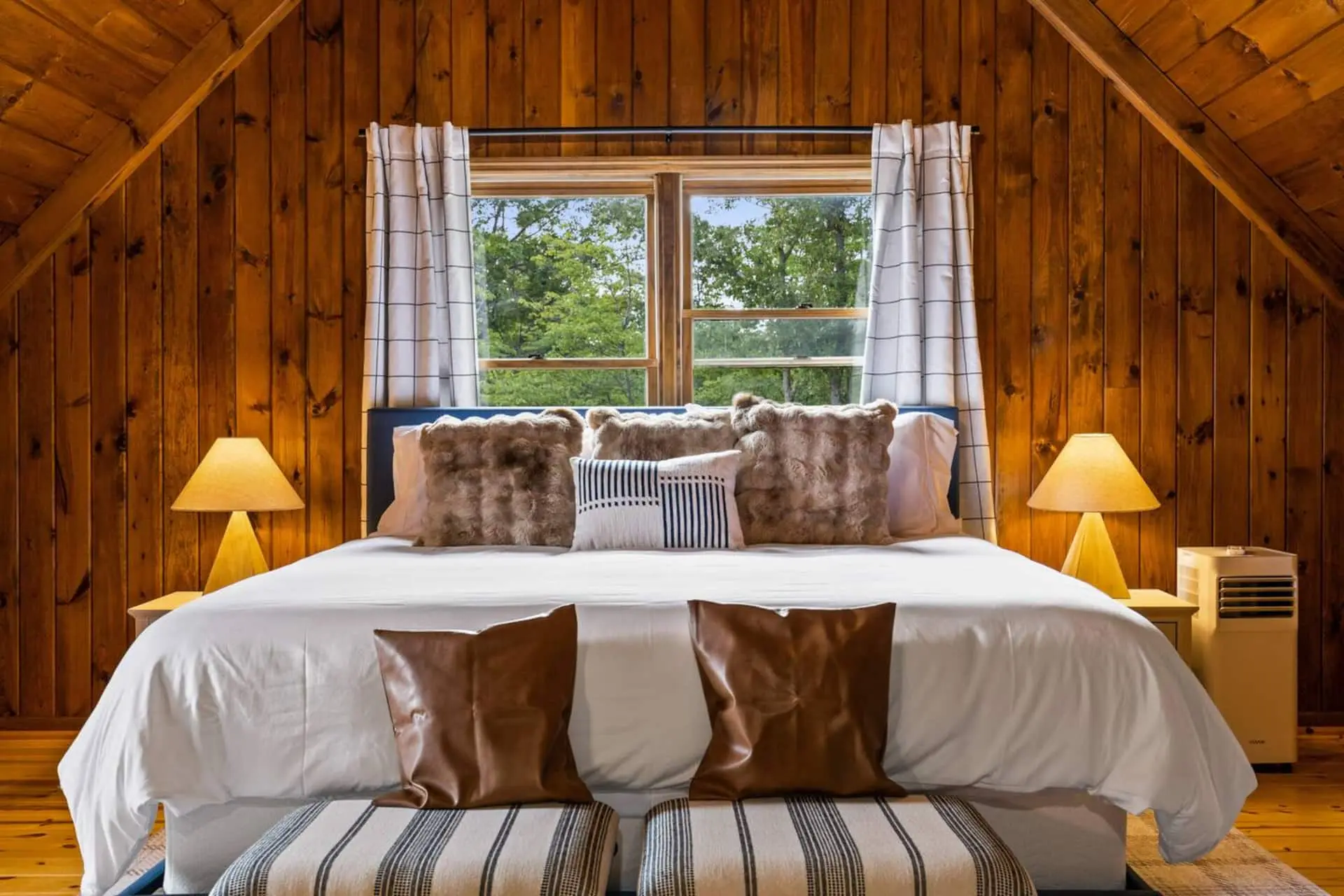 Loft king bed decorated in warm mountain colors and textures - you may want to just stay indoors!