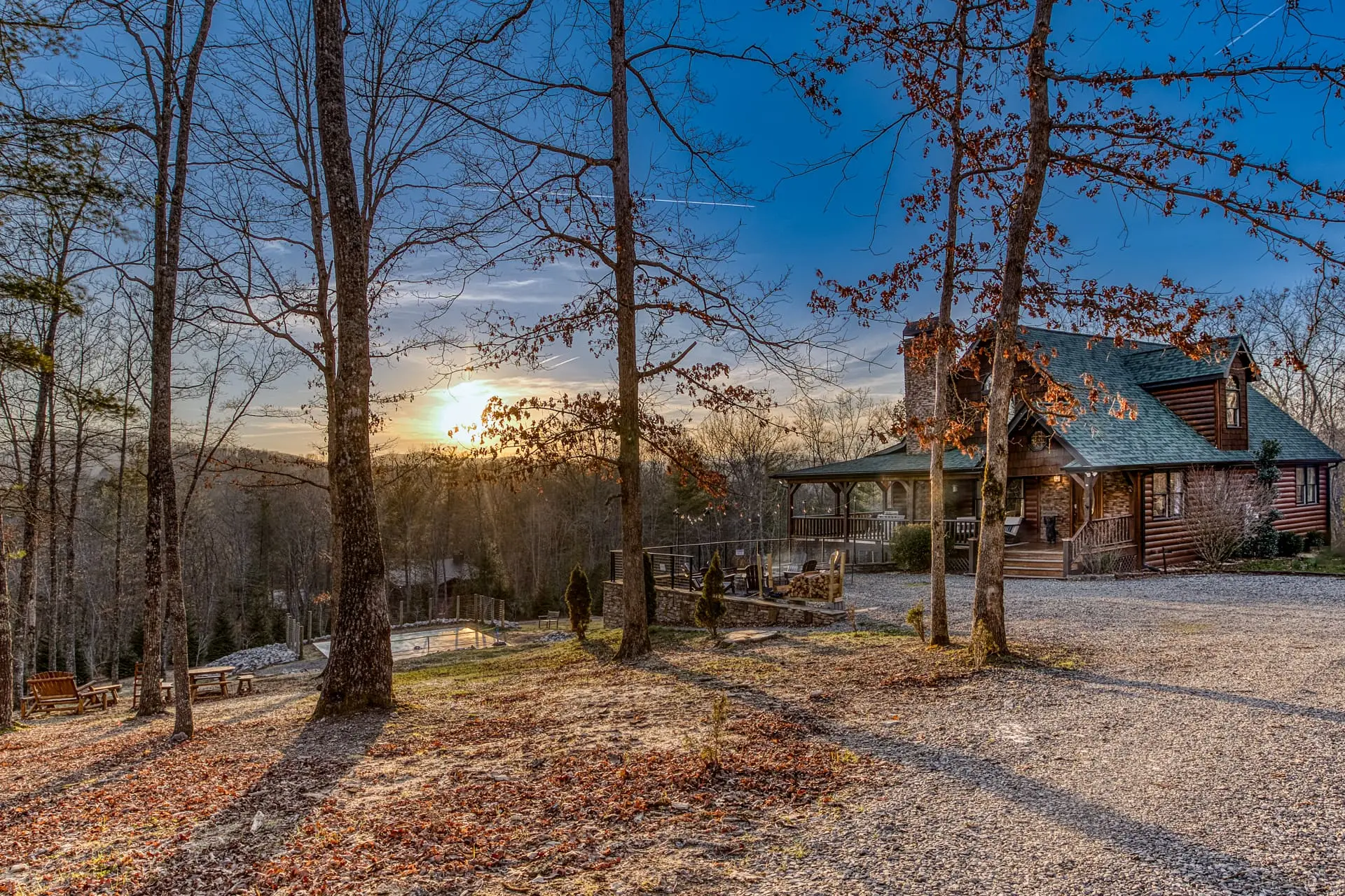 Secluded log cabin with wraparound porch and glowing sunset views