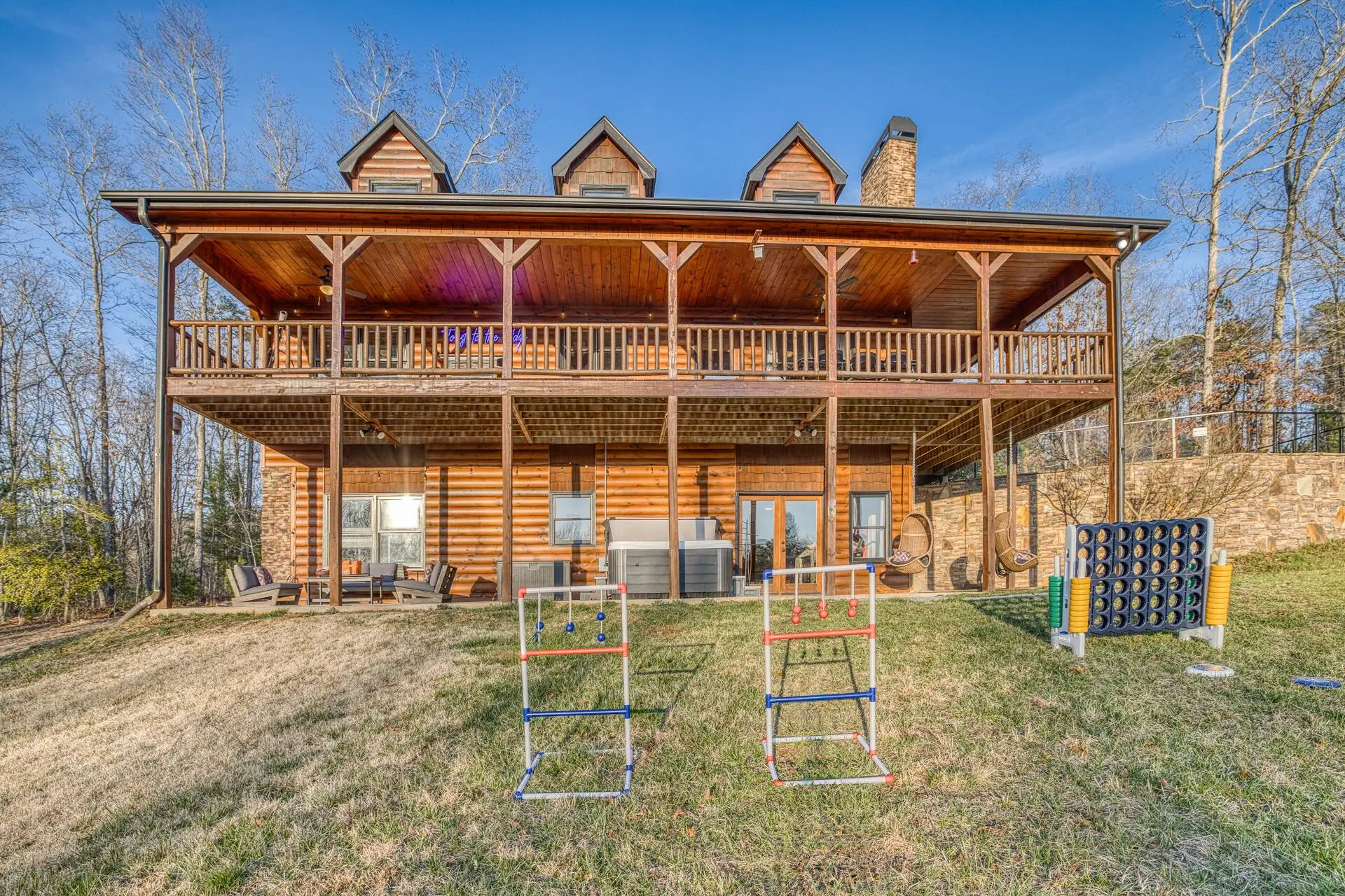 Spacious log cabin with double decks, yard games, and wooded views